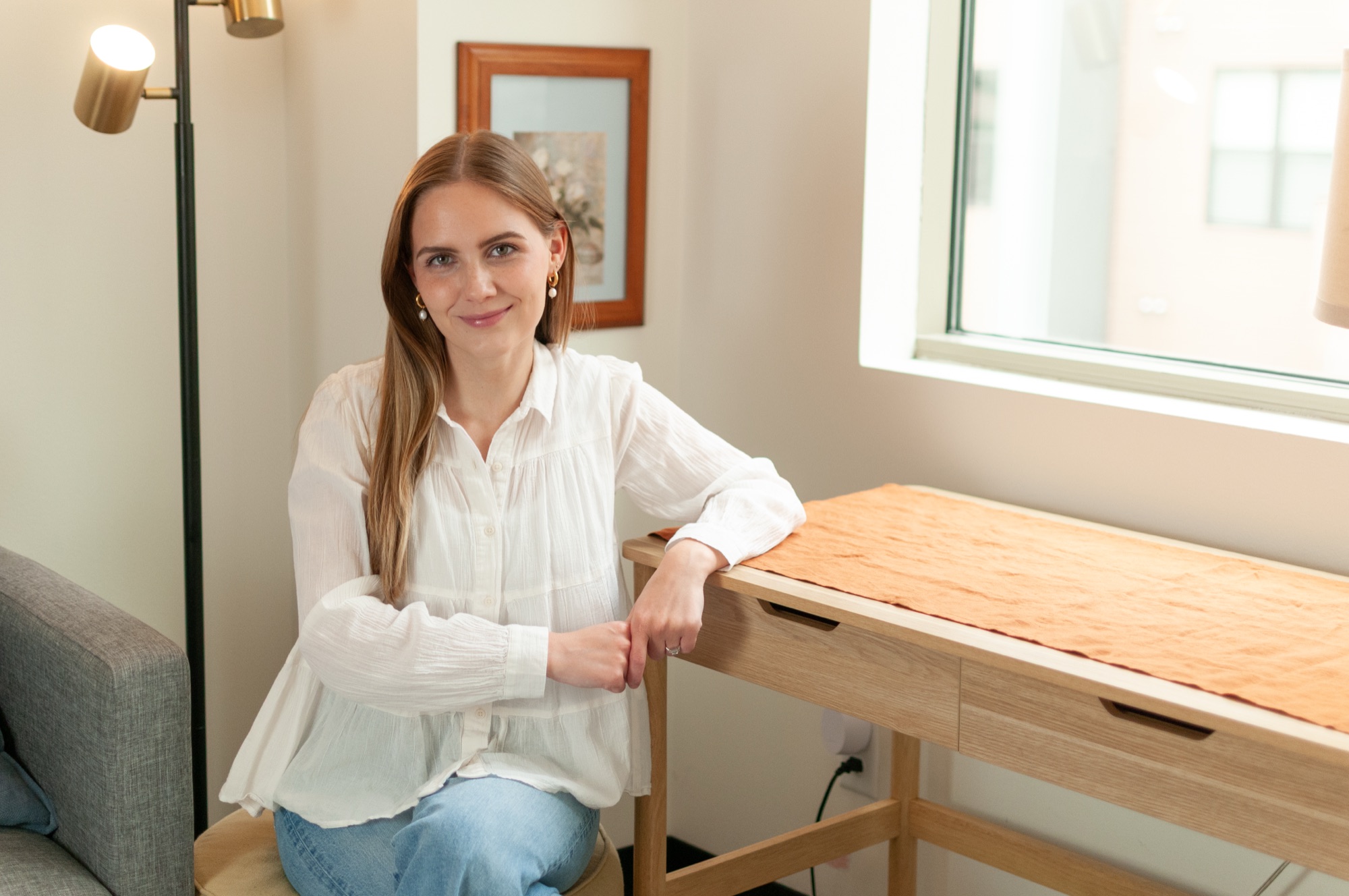 Olivia Brooks, marriage and family therapist, at the desk in her Nashville office